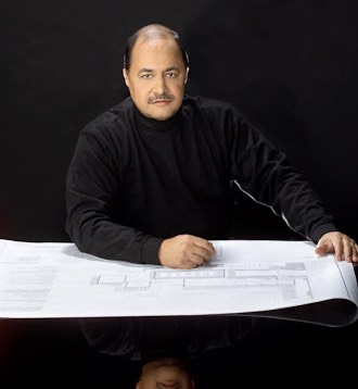 Man lookng and architectural plans